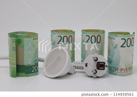 White electric cable and banknotes, expensive electricity, saving electricity. White electric cable and banknotes, expensive electricity, saving electricity. 114939561