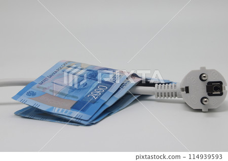 White electric cable and banknotes, expensive electricity, saving electricity. White electric cable and banknotes, expensive electricity, saving electricity. 114939593