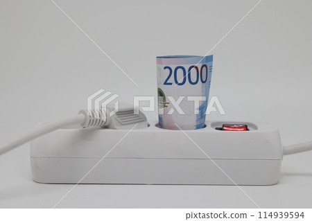 White electric cable and banknotes, expensive electricity, saving electricity. White electric cable and banknotes, expensive electricity, saving electricity. 114939594