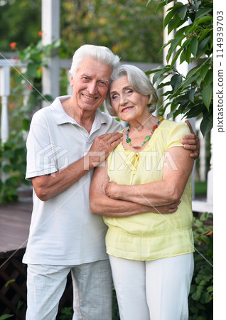 Portrait of beautiful senior couple by lilacs in the park Portrait of beautiful senior couple by lilacs in the park 114939703