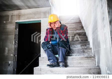Older worker feeling strong headache. Stroke symptoms. Migraine as severe headache with throbbing pain. 114939811