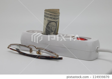 White electric cable and banknotes, expensive electricity, saving electricity. White electric cable and banknotes, expensive electricity, saving electricity. 114939870