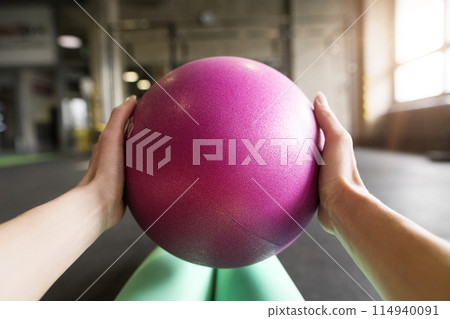 Beautiful sport woman exercising on gym mat with medicine ball. Routine workout for woman's physical and mental health. Beautiful sport woman exercising on gym mat with medicine ball. Routine workout for woman's physical and mental health. 114940091