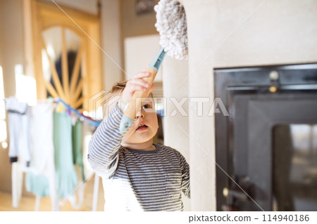 Little boy helping mother with hosehold chores, dusting cleaning their house. Weekly chores, weekend activities. Little boy helping mother with hosehold chores, dusting cleaning their house. Weekly chores, weekend activities. 114940186