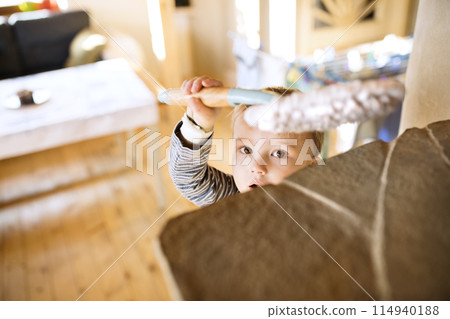 Little boy helping mother with hosehold chores, dusting cleaning their house. Weekly chores, weekend activities. Little boy helping mother with hosehold chores, dusting cleaning their house. Weekly chores, weekend activities. 114940188