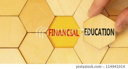 Financial education symbol. Concept words Financial education on beautiful wooden puzzles. Beautiful yellow background. Businessman hand. Business Financial education concept. Copy space. 114941014