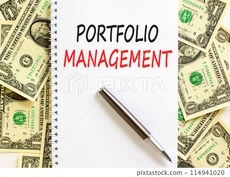 Portfolio management symbol. Concept words Portfolio management on beautiful white note. Beautiful dollar bills background. Black pen. Dollar bills. Business Portfolio management concept. Copy space. 114941020