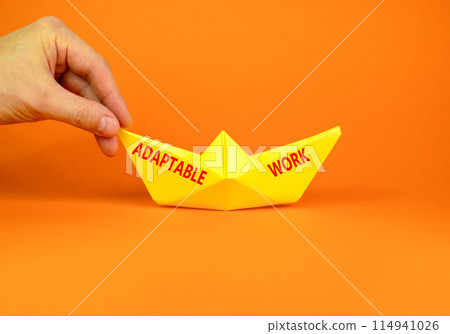 Adaptable work symbol. Concept words Adaptable work on beautiful yellow paper boat. Beautiful orange paper background. Businessman hand. Business Adaptable work concept. Copy space. Adaptable work symbol. Concept words Adaptable work on beautiful yellow paper boat. Beautiful orange paper background. Businessman hand. Business Adaptable work concept. Copy space. 114941026