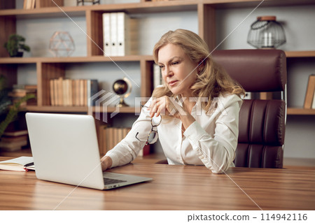 Confident woman psychologist using laptop for virtual appointment with her patient Confident woman psychologist using laptop for virtual appointment with her patient 114942116