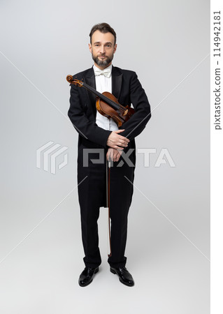 Bearded man artistic violinist with instrument in hands 114942181
