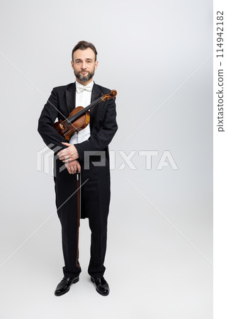 Musician man with violin in hands at concert 114942182