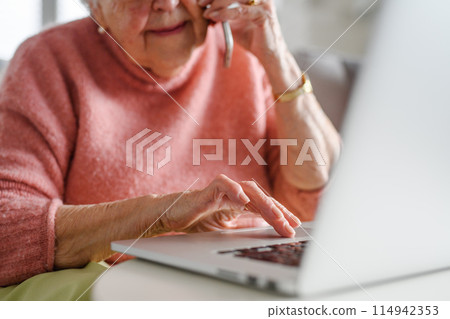 Online and phone scams targeting seniors. Scammer sending email to elderly woman, asking for money, demanding personal, sensitive informations without verification. Online and phone scams targeting seniors. Scammer sending email to elderly woman, asking for money, demanding personal, sensitive informations without verification. 114942353