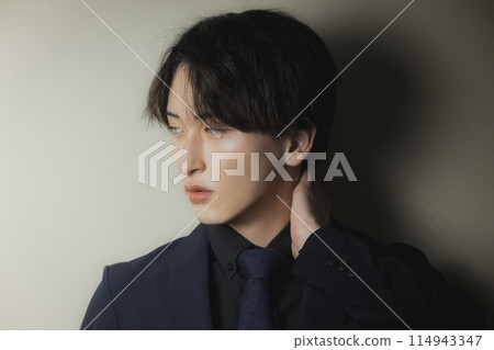 Man in black suit 114943347