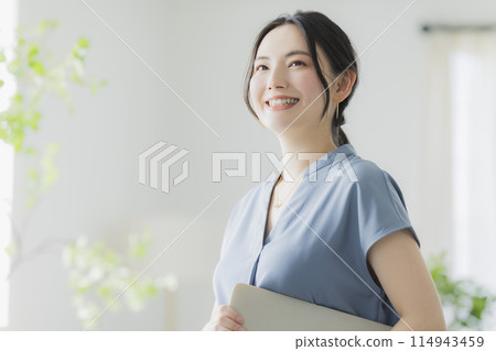 A woman with a laptop A woman with a laptop 114943459