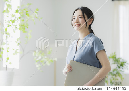 A woman with a laptop A woman with a laptop 114943460