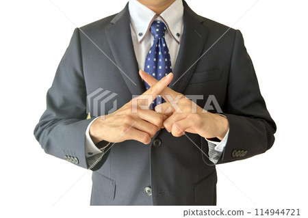 A man in a suit making a "X" sign with his fingers A man in a suit making a "X" sign with his fingers 114944721