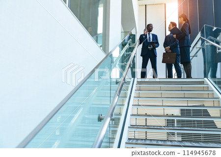 Group of multinational business people having a conversation in a lobby Group of multinational business people having a conversation in a lobby 114945678