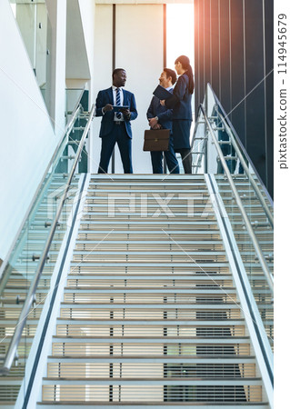 Group of multinational business people having a conversation in a lobby Group of multinational business people having a conversation in a lobby 114945679