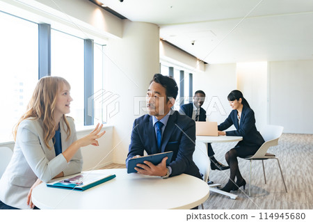 Group of multinational business people having a conversation in a lobby 114945680