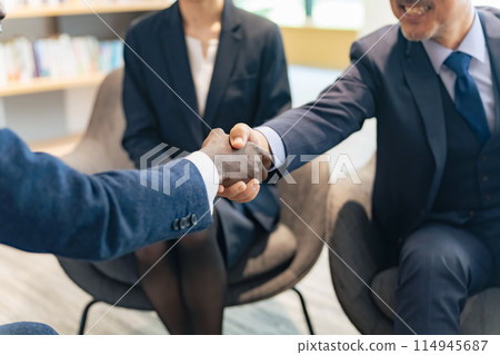 Group of multinational business people shaking hands in a lounge 114945687