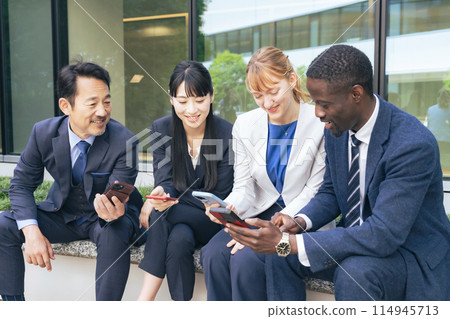 A group of multinational business people having a conversation using a smartphone translation app 114945713