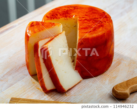 Tasty french goat cheese with pepper, slices at wooden desk 114946232