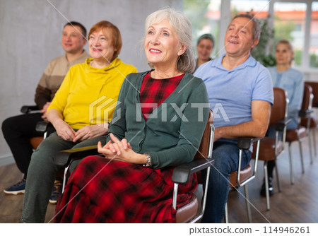 Interested elderly woman listening lesson during language courses Interested elderly woman listening lesson during language courses 114946261