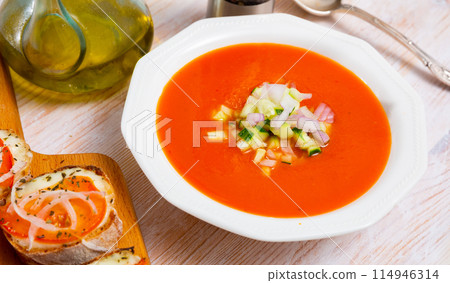Andalusian cold soup gaspacho served with hot sandwiches 114946314