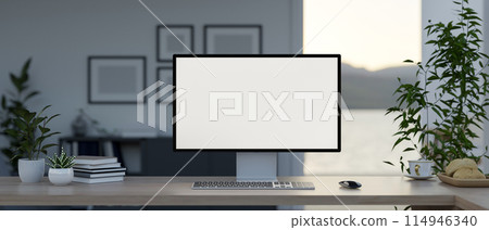 A computer with a white-screen mockup and accessories on a table in a modern private office. A computer with a white-screen mockup and accessories on a table in a modern private office. 114946340