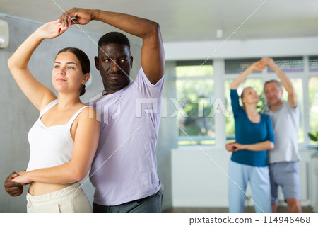 Young girl dancing merengue with African American partner 114946468