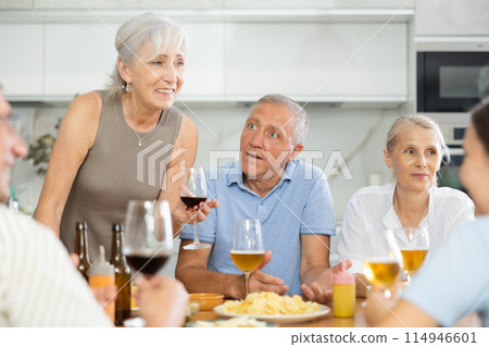 Elderly people drinking and chatting at table Elderly people drinking and chatting at table 114946601
