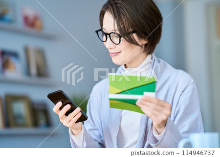 A woman looking at her bank account passbook A woman looking at her bank account passbook 114946737