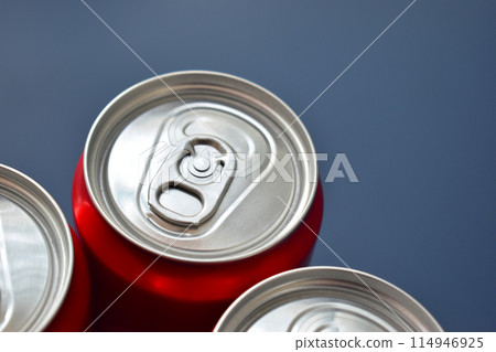 close up top of aluminium red cans soft drink put on blue texture background 114946925