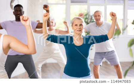 Senior woman dances learn to move energetically to beat of music 114947083