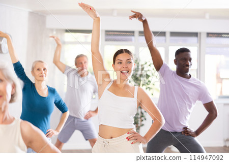 Young girl dance instructor conducting class for adults Young girl dance instructor conducting class for adults 114947092