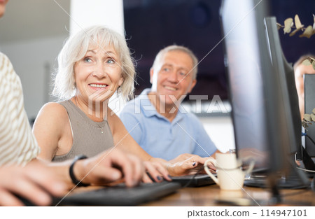 Enthusiastic senior woman attending computer class for older adults Enthusiastic senior woman attending computer class for older adults 114947101