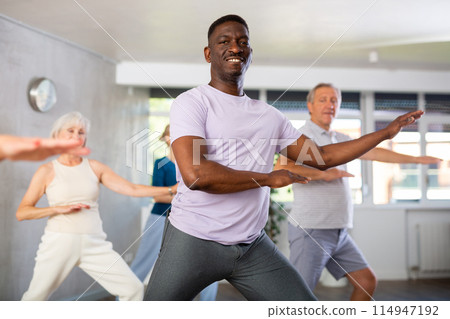 African American man dancing hip hop in studio practicing dance number. African American man dancing hip hop in studio practicing dance number. 114947192