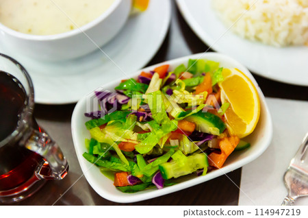 Choban salad from tomatoes, cucumbers, greens, onions with lemon Choban salad from tomatoes, cucumbers, greens, onions with lemon 114947219