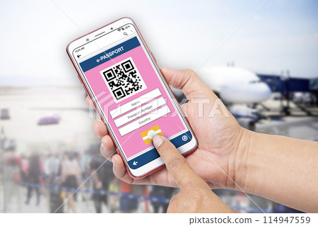 Hand holding smartphone showing e-passport application on screen. Hand holding smartphone showing e-passport application on screen. 114947559