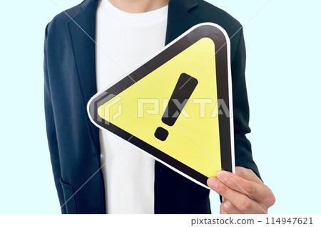 A man calling for caution and a warning sign A man calling for caution and a warning sign 114947621