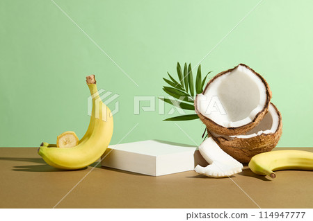 Photograph for promotion was shot from front, it has a rectangular pedestal in white for displaying product of culinary, beverage or cosmetic made from tropical fruit such as coconut and banana Photograph for promotion was shot from front, it has a rectangular pedestal in white for displaying product of culinary, beverage or cosmetic made from tropical fruit such as coconut and banana 114947777