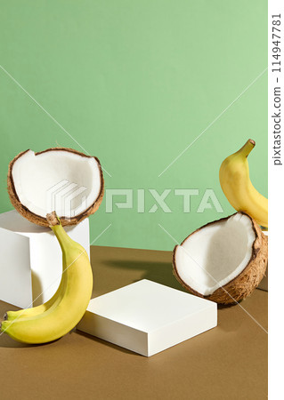 Vertical photograph was taken from front view on green color texture, brown countertop contains a few blank showcase stage for advertise product has coconut and banana origin, space for text Vertical photograph was taken from front view on green color texture, brown countertop contains a few blank showcase stage for advertise product has coconut and banana origin, space for text 114947781