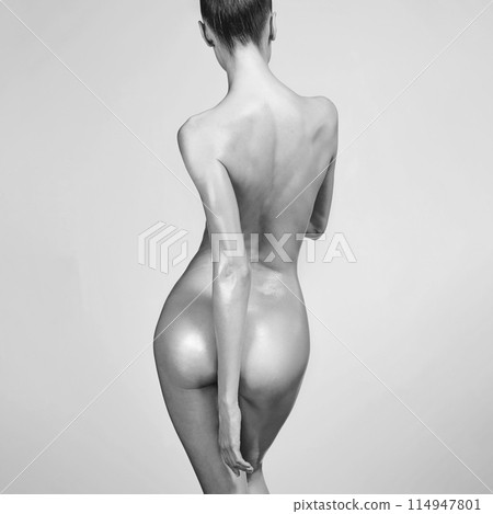 Sexy naked girl with a beautiful body posing in a photo studio. Sexy naked girl with a beautiful body posing in a photo studio. 114947801