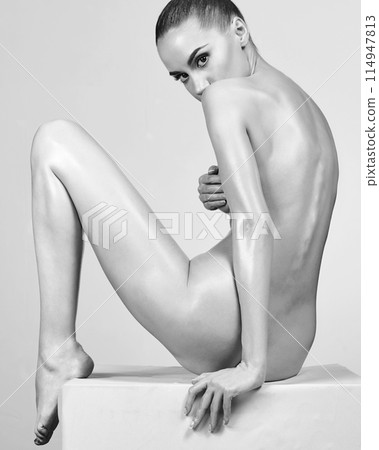 Sexy naked girl with a beautiful body posing in a photo studio. Sexy naked girl with a beautiful body posing in a photo studio. 114947813