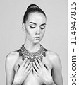 Sexy naked girl with a beautiful body posing in a photo studio. 114947815