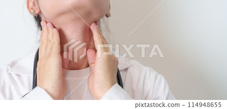 Woman checking Thyroid gland disease. Hand holding Neck pain. Hyperthyroidism, Hypothyroidism, Hashimoto Thyroiditis, Thyroid Tumor and Cancer, Postpartum, Papillary Carcinoma and Health concept 114948655