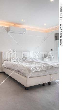 Air conditioner and bed in a white minimal style room. Air conditioner and bed in a white minimal style room. 114948888