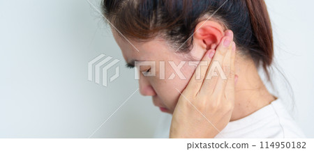 Woman holding her painful Ear. Ear disease, Atresia, Otitis Media, Inflation, Pertorated Eardrum, Meniere syndrome, otolaryngologist, Ageing Hearing Loss and Health concept Woman holding her painful Ear. Ear disease, Atresia, Otitis Media, Inflation, Pertorated Eardrum, Meniere syndrome, otolaryngologist, Ageing Hearing Loss and Health concept 114950182