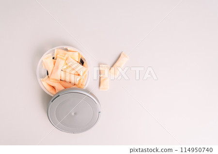 Plastic jar with fruit flavored snus sachets on a light background Plastic jar with fruit flavored snus sachets on a light background 114950740