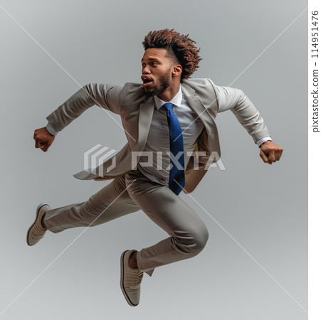 Businessman with fly-away tie in mid-air leap Businessman with fly-away tie in mid-air leap 114951476